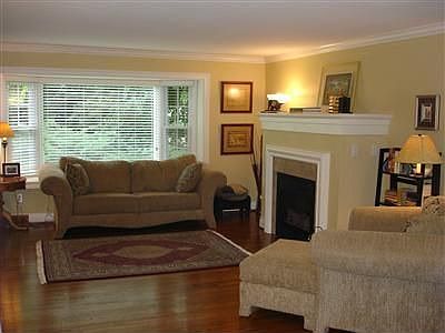 Living room with gas fireplace and bay windows
