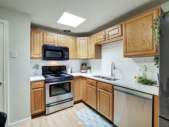 The kitchen features stainless appliances and a pantry closet.  Cabinets have been updated with quartz countertops and new pulls