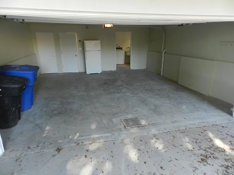Garage with storage room and entry to home