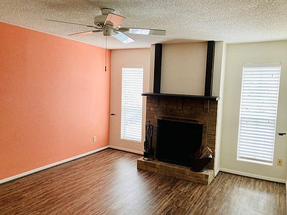 Living room with wood burning fireplace.
