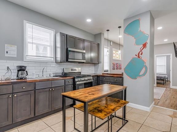 Updated kitchen w/ oven/range, built-in microwave, and full size refrigerator w/ freezer