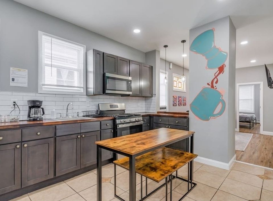 Updated kitchen w/ oven/range, built-in microwave, and full size refrigerator w/ freezer