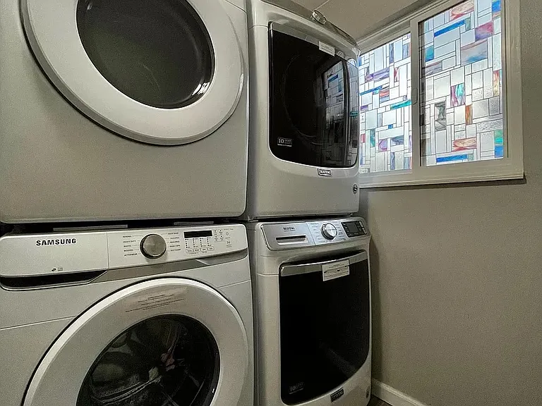 This laundry room is shared with all 4 apartments. Two washing machines on the bottom and two dryers on the top.