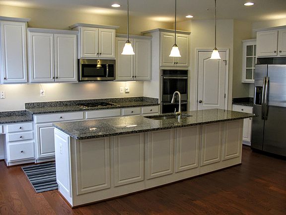 KITCHEN WITH GRANITE COUNTER TOP AND PLANNING DESK AT THE LEFT CORNER