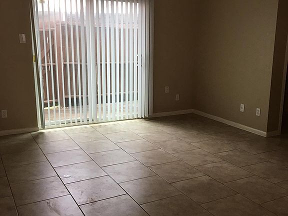 Living room area and sliding door leading to patio