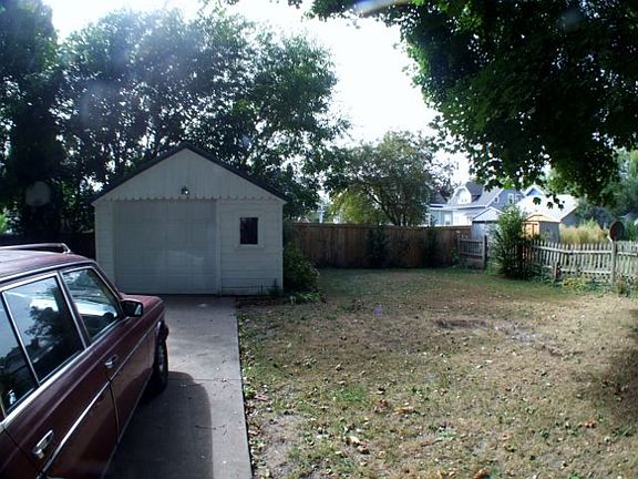 Partially fenced back yard and garage