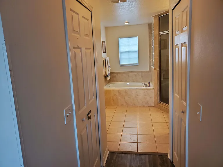 master bathroom with garden soaking tub and steam shower