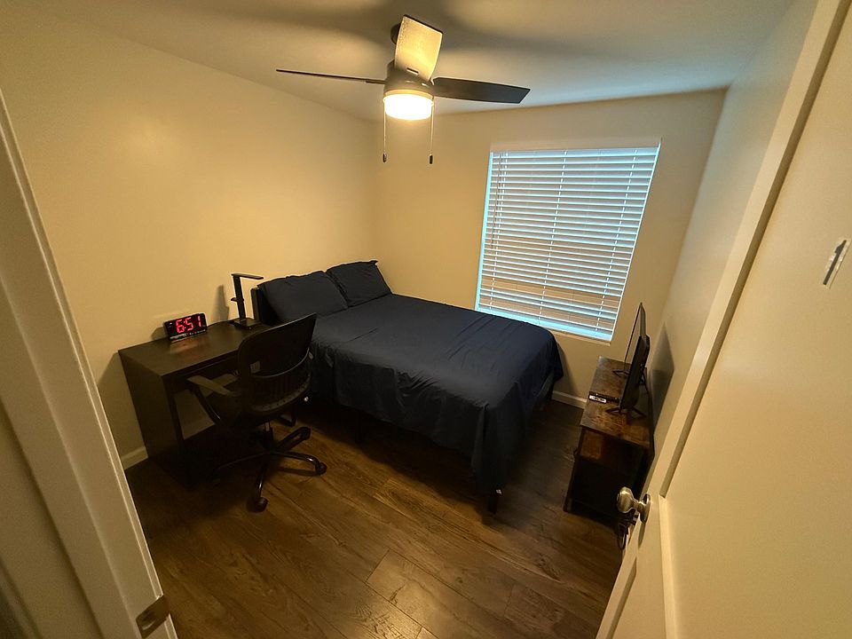 Includes work table, seating chair, ventilation, tv, ceiling fan, window and closet to hang clothing and add luggage into.