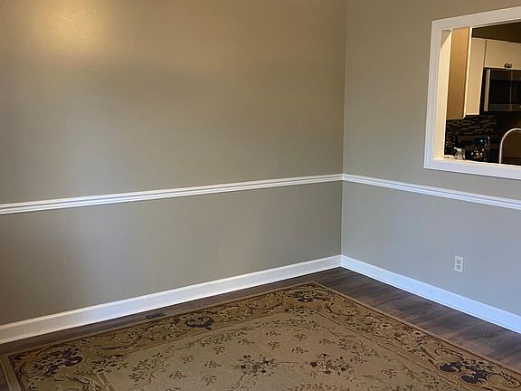 Formal dining with false window into kitchen.