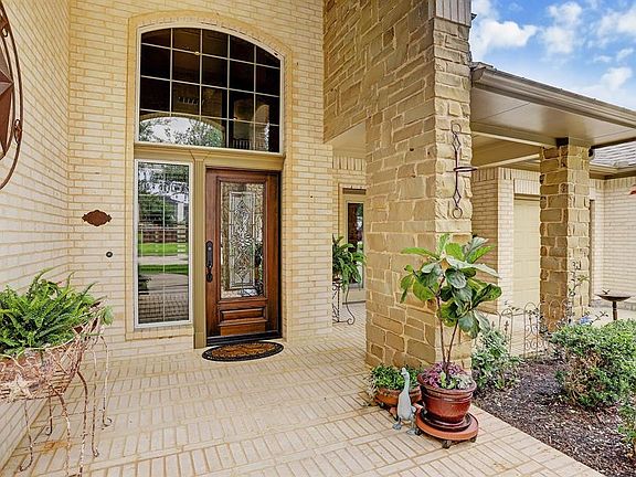 Lovely stone and brick front elevation with a covered front porch. Updated leaded glass front door.