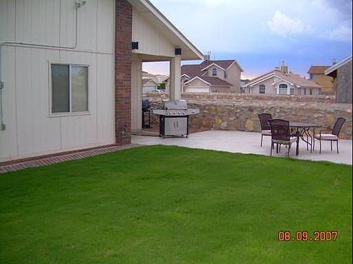 Plush grass with automatic sprinkler system and patio area