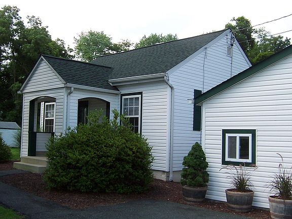 One and one-half car garage (20x24) with side door and windows, electric and work benches. Big parking pad also.