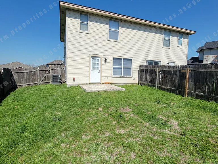 Fenced backyard with patio