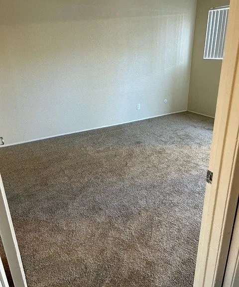 Spacious carpeted bedroom at Mission Bell Apartments.