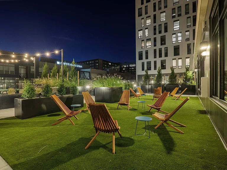 Enjoy the soft, green flooring of the patio's grassy area, ideal for outdoor lounging.