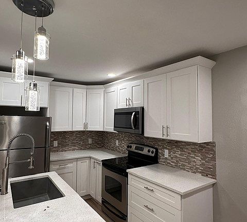 open beautiful new kitchen, with dishwasher, refrigerator, microwave and stove with oven