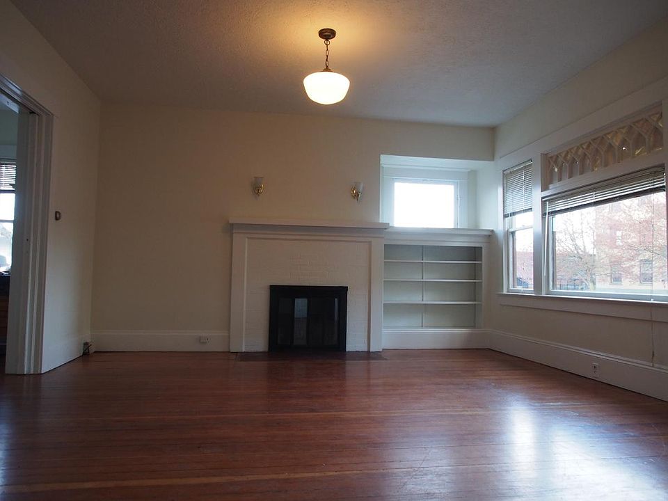 Living room features period lighting, fir floor, working fir