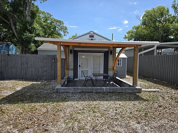 Large, covered tiled patio with furniture included (new table, 4 chairs and umbrella).