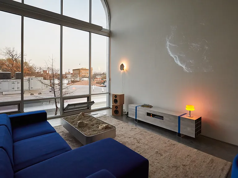Living room with couch and floor to ceiling windows