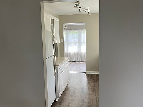 Front room looking into kitchen and back room.