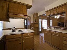 The kitchen was updated in the 1980's with solid wood cabinets. Notice how the kitches is so open to