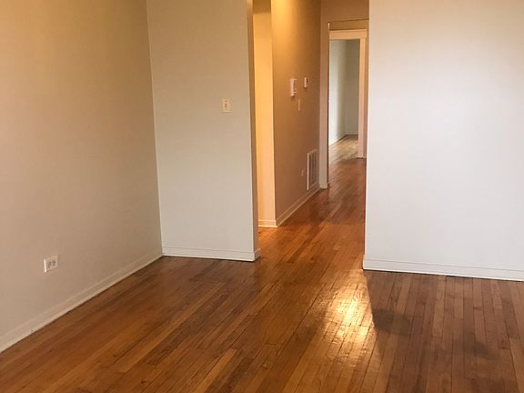 Dining room looking toward hall to front of apartment, bedrooms, living room, and front door.