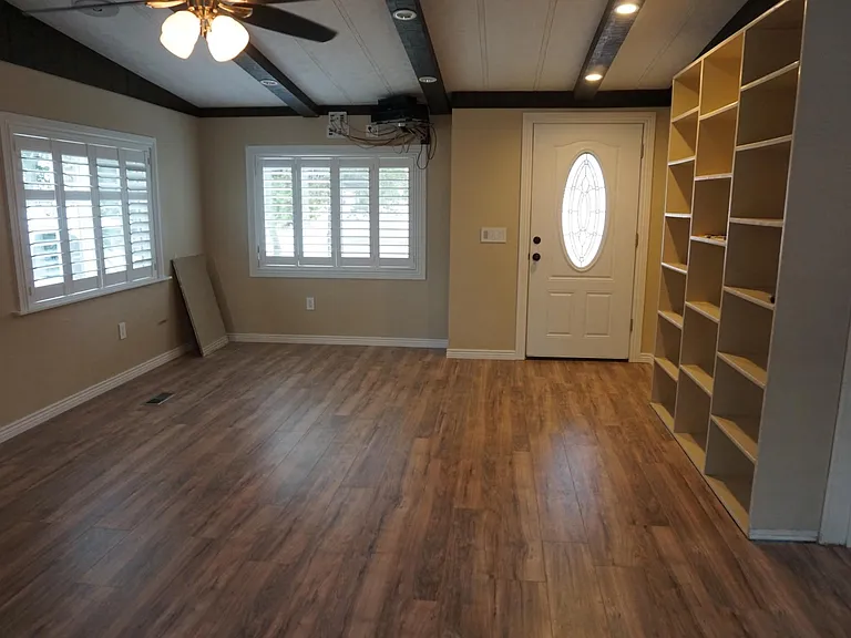 Front room, facing front door. Can see sound system controls above window.