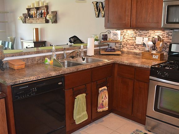 Kitchen complete with all SS & black appliances, access to the garage,
