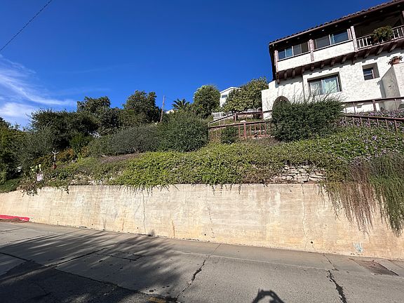 Your unit starts where you see the arch, on the left. The first-floor large window is in the queen bedroom. The small window is the bathroom's. The potted geranium is perched on your balcony's ledge.