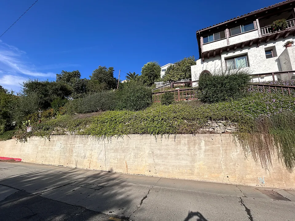Your unit starts where you see the arch, on the left. The first-floor large window is in the queen bedroom. The small window is the bathroom's. The potted geranium is perched on your balcony's ledge.