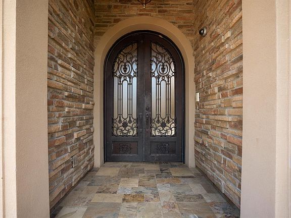 Impressive front alcove porch with Canterra double entry doors.