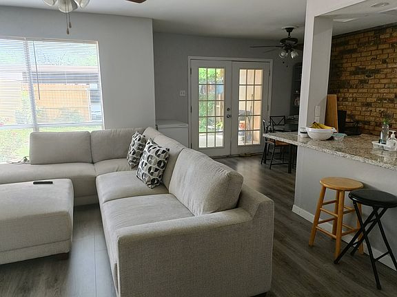 living room and open kitchen countertop with sit in