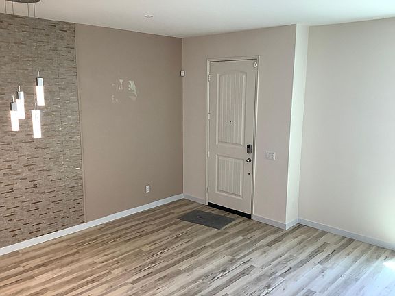 Entry door next to dinning area and living room