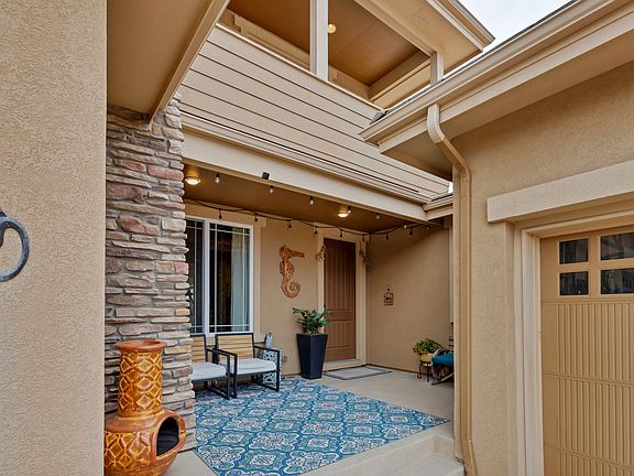Sheltered front entry and a comfortable outdoor sitting area.