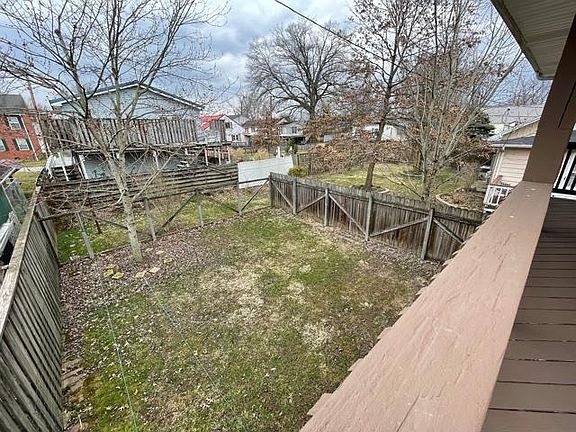 Fenced in area attached to apartment, within larger larger fenced in property.