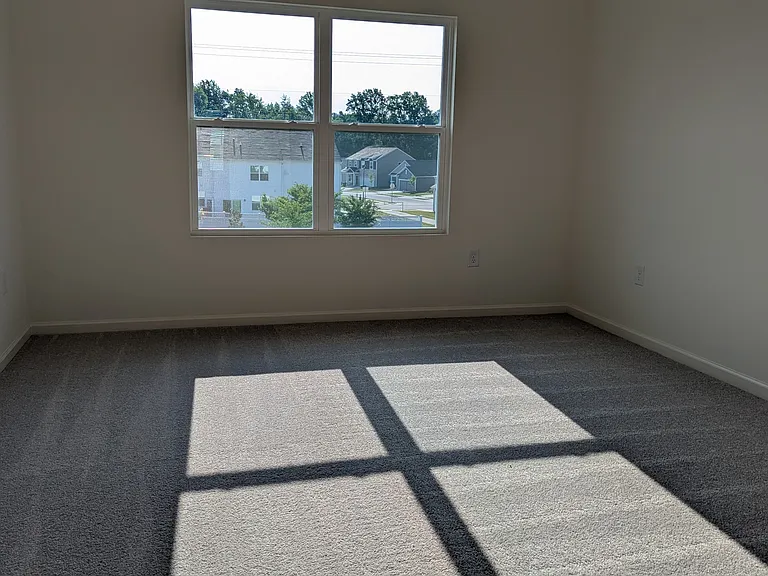 Primary bedroom comfortably fits King sized bedroom suite.