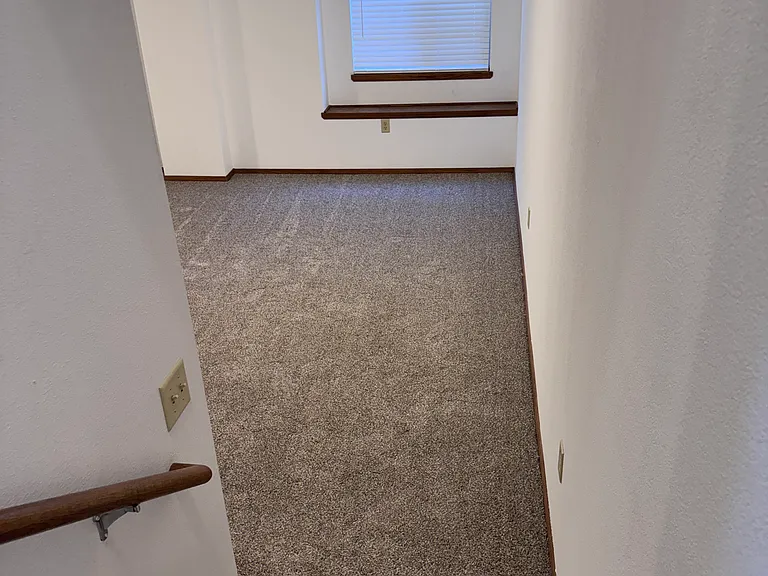 Stairs leading to Large family room. Also showing daylight window and basement escape.