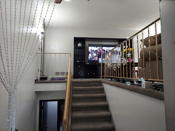 Split level home. Stairs up to the living room, two bedrooms, bathroom, and dining room/kitchen, large, attached deck