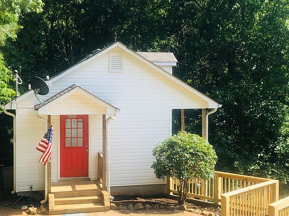 Adorable exterior with woods on 2 sides of home. Very peaceful.