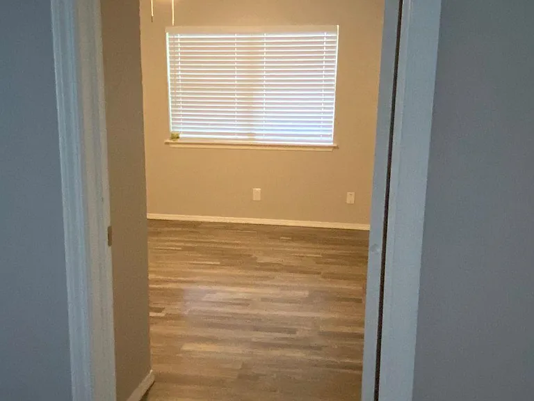 Comfortable bedroom with ceiling fan and pleasant outside view.