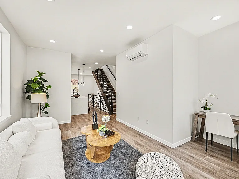 Great open-concept main living area filled with natural light complete with wood stairs and other beautiful designer finishes.