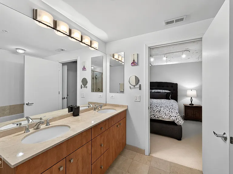 This ensuite bathroom includes a double vanity, and separate shower and bathtub.