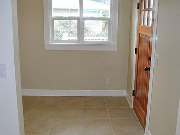 Entry and front door. Tile floor. Fir door. Windows facing west, sash with screens.