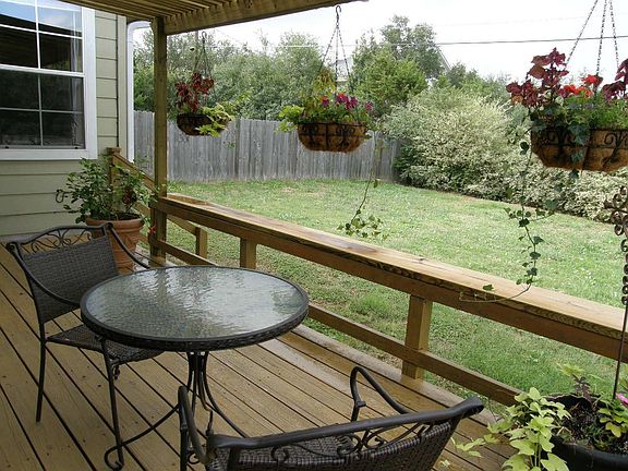 Large, fenced backyard with covered deck