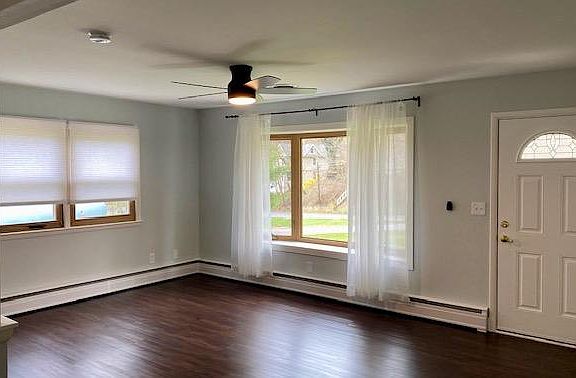 Living room with bay window overlooking front yard.