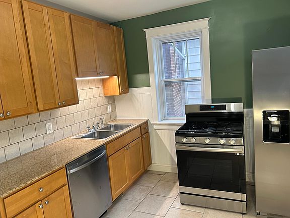 Updated kitchen with all stainless steel appliances and marble counter top.
