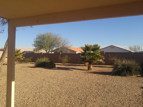 Fully fenced backyard with covered porch