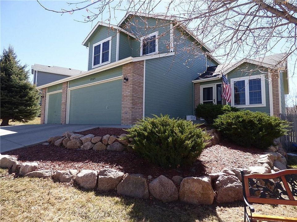 Front of home with beautiful landscaping, 3 car garage updated windows