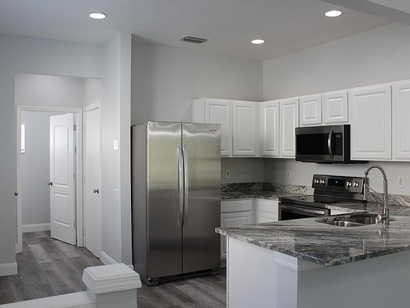 Kitchen, with powder bath, adjacent pantry and garage access.