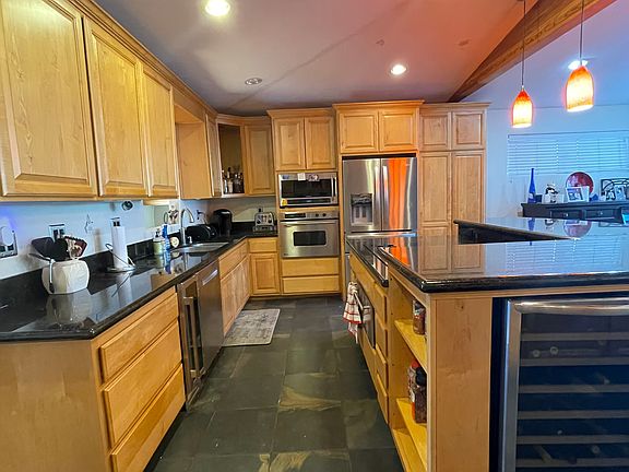 Kitchen including wine cooler, microwave, oven, stove, warming drawers, dishwasher and plenty of storage.